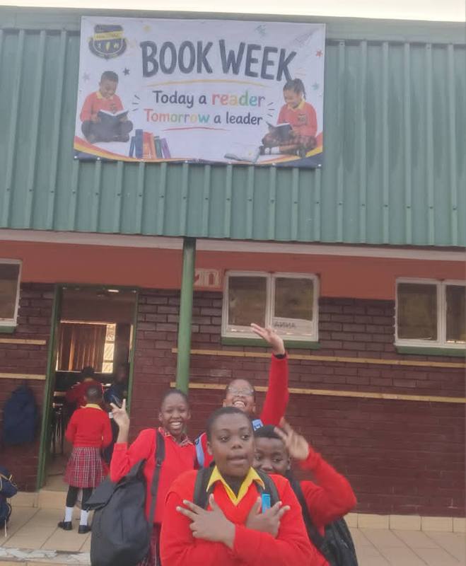 Pupils outside the school under the Book Week banner