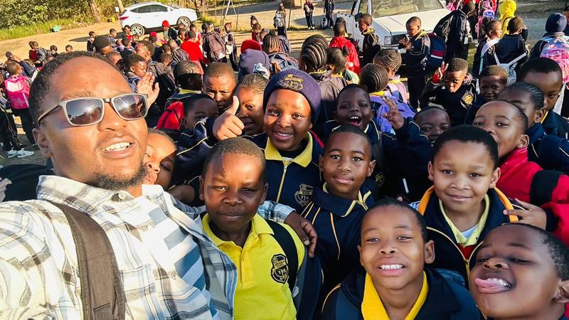 A teacher and pupils gathered together on an outing
