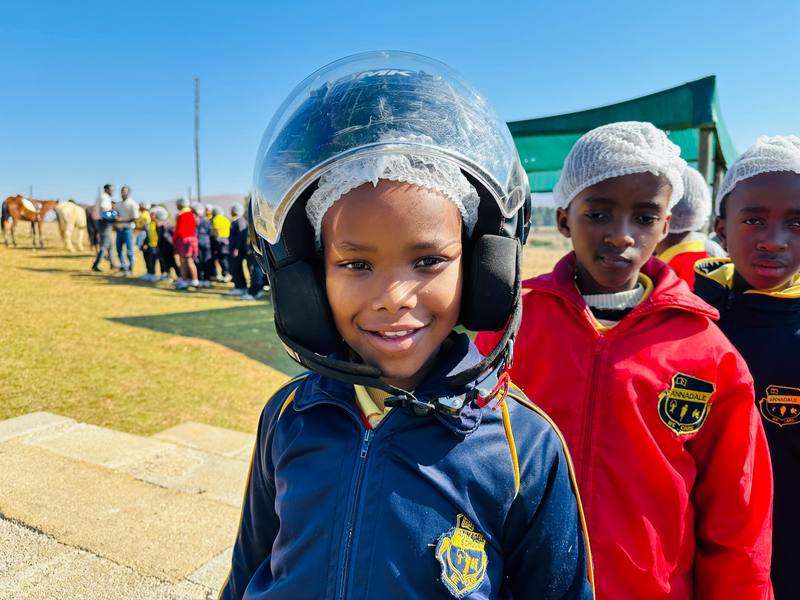 Pupils in helmets waiting their turn on the quad bikes