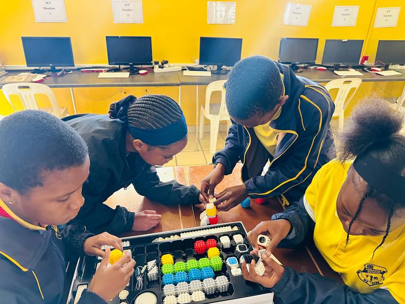 A group of pupils working together on a coding activity