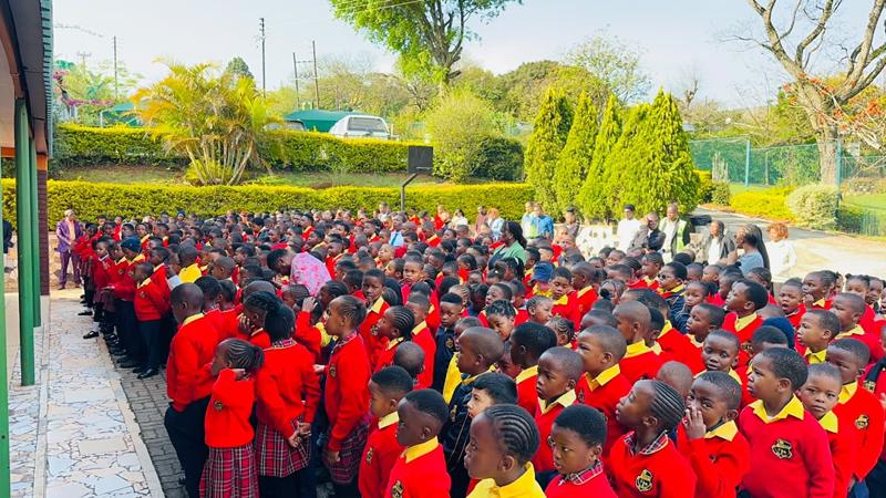 Pupils gathered for a whole-school assembly in the school gardens